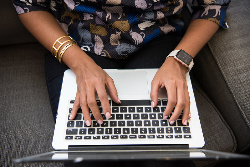 Woman of color typing on computer