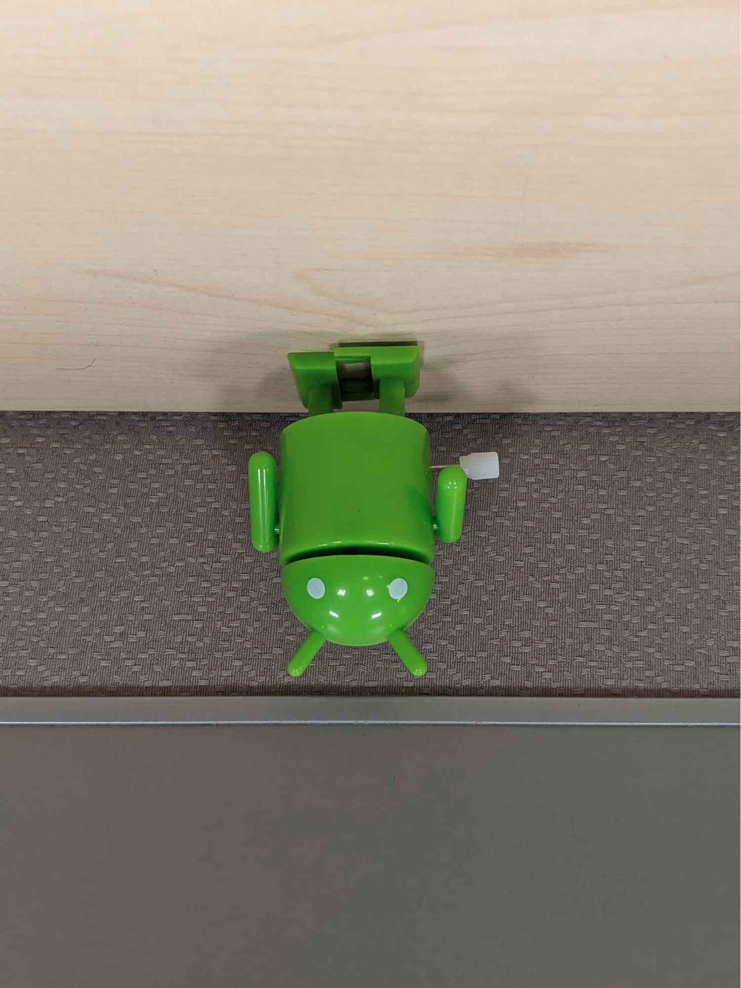 A portrait-shaped image with the bugdroid's head pointed downwards