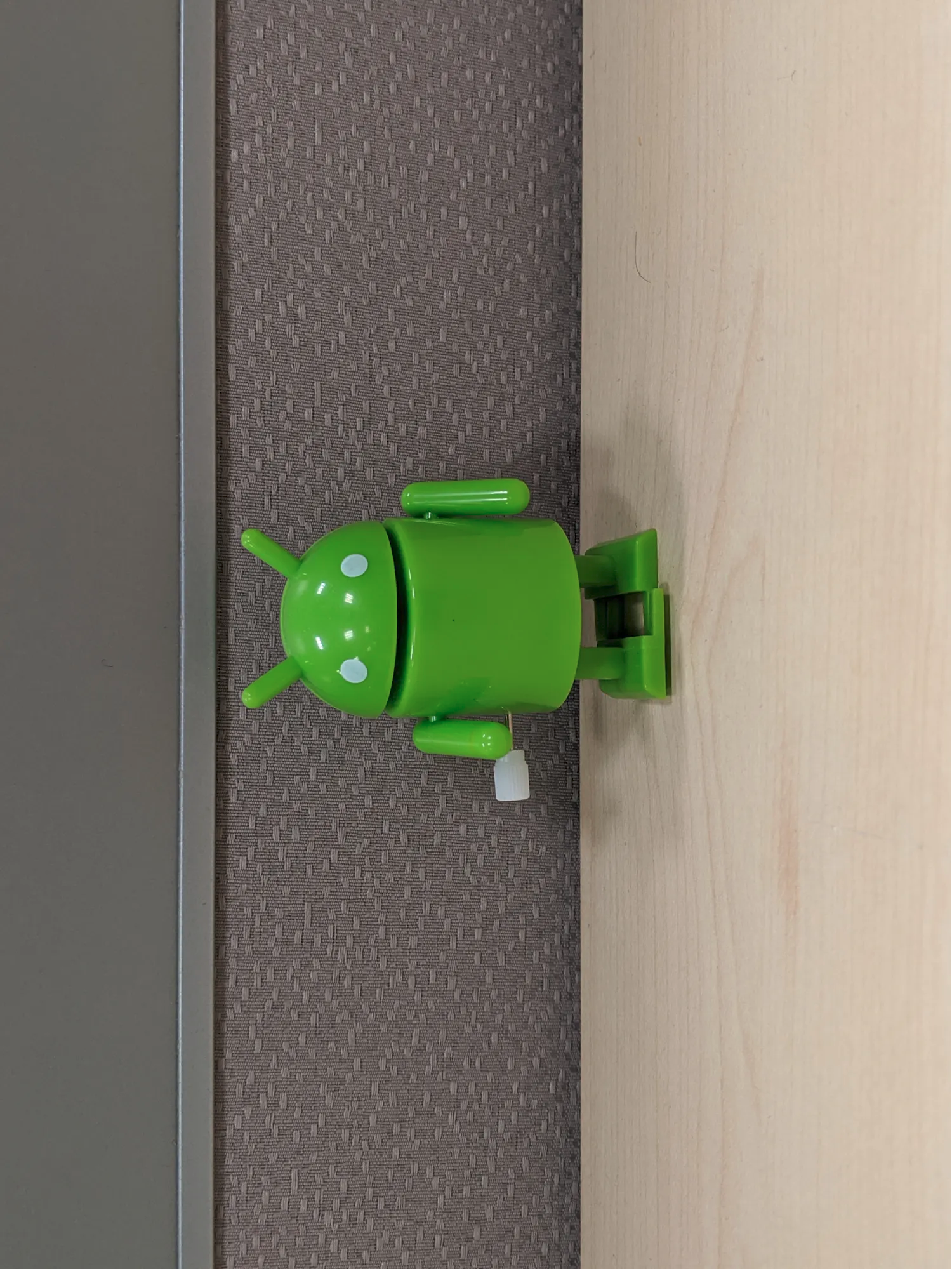A portrait-shaped image with the bugdroid's head pointed to the left
