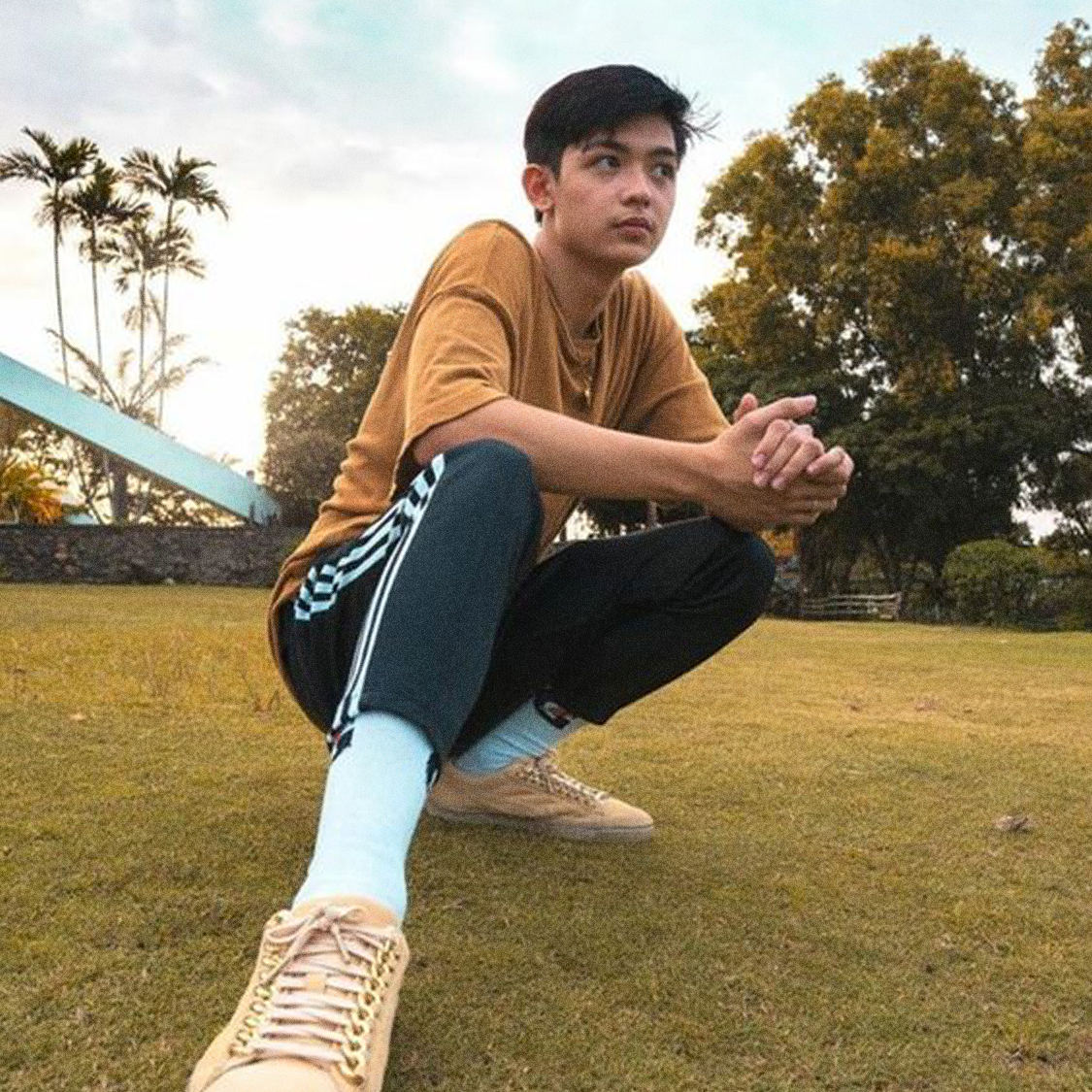 Photo of Noel on a field posing for the camera