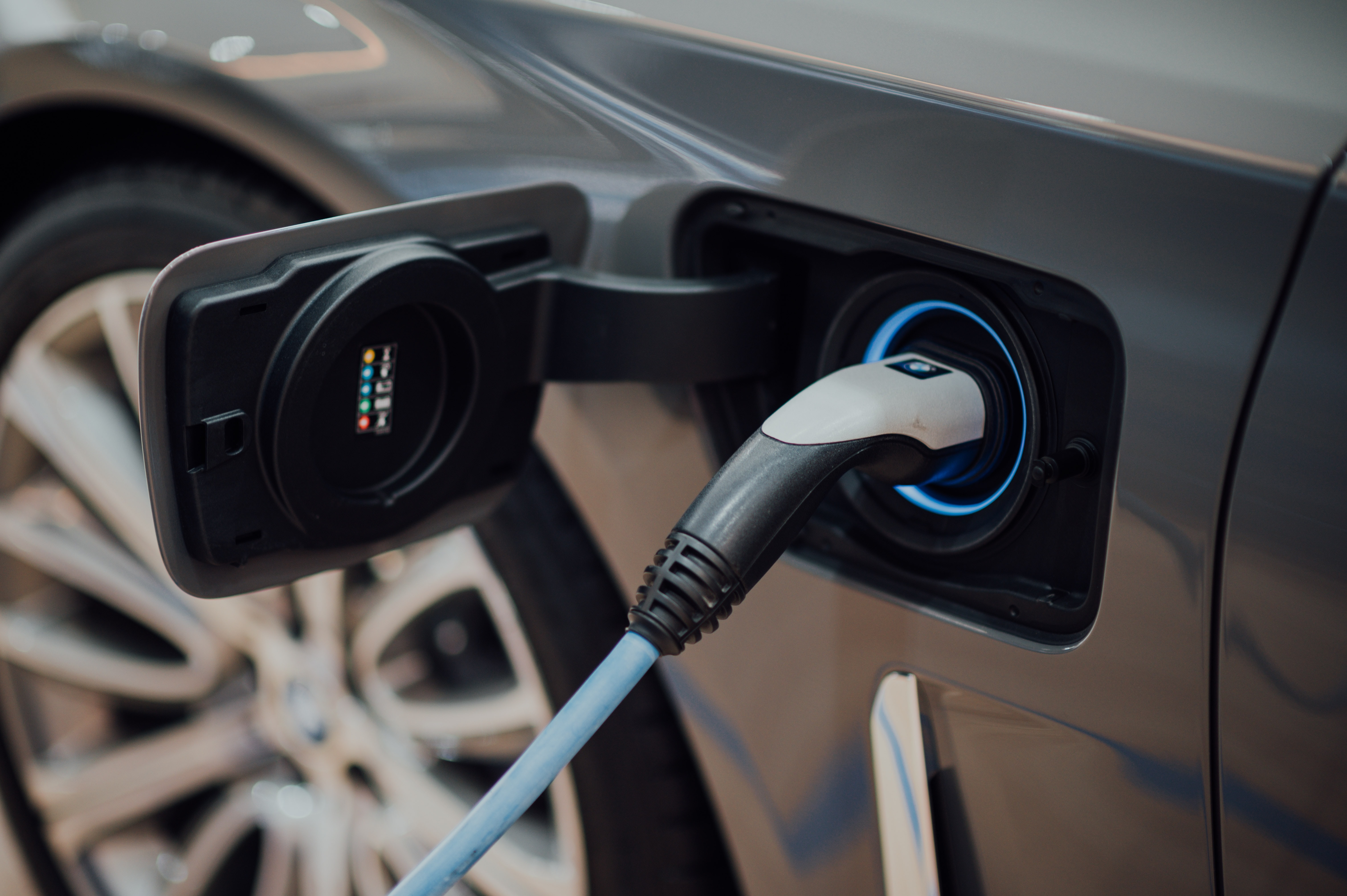 Charging electric car sign on green background