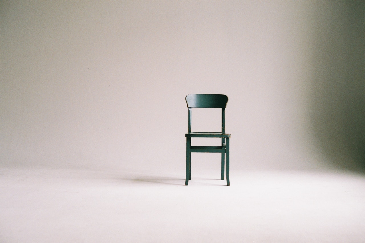 a wooden chair in an empty room