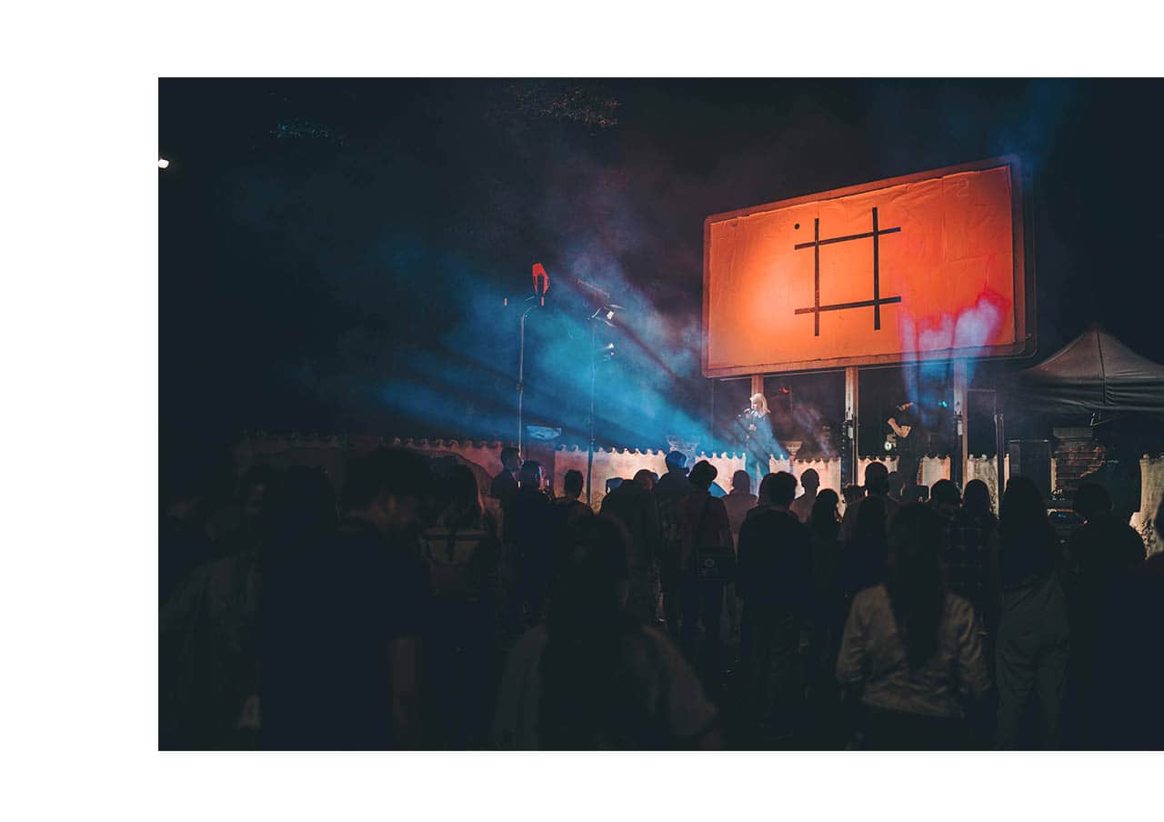 Photo from concert with billboard with my design behind the performers